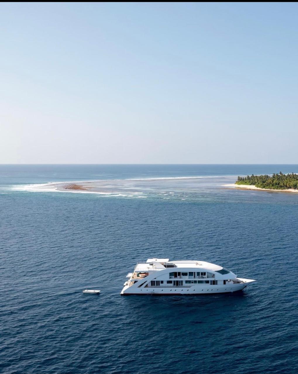 The yacht Mosaique anchored off a Maldivian reef